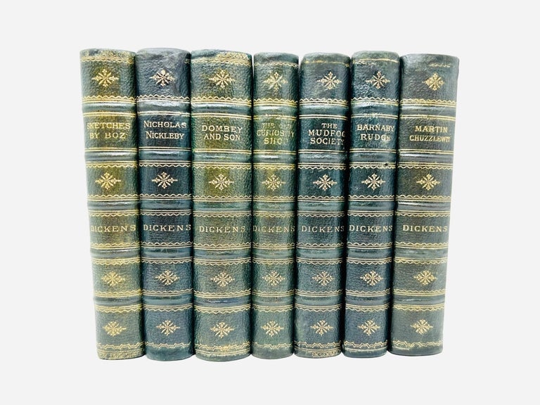 Item #50 A stunning set of seven volumes of Charles Dicken’s works, including the following titles: Sketches by “Boz”, The Life and Adventures of Nicholas Nickleby, Dombey and Son, The Old Curiosity Shop, The Mudfog Society, Barnaby Rudge, and The Life and Adventures of Martin Chuzzlewit. Charles Dickens.